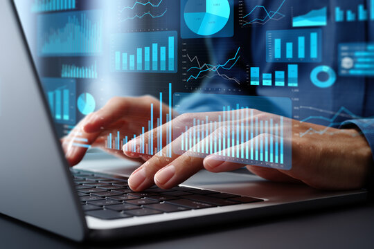 Digital Marketing Analysis happening hands typing on a laptop with digital graphs and charts overlaying the screen.